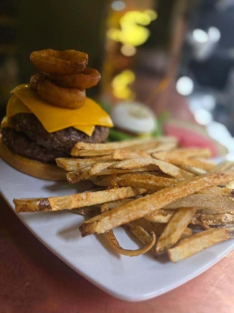 The Black Steer Burger — a one-pound double-decker burger served with onion rings in Loveland, Colorado