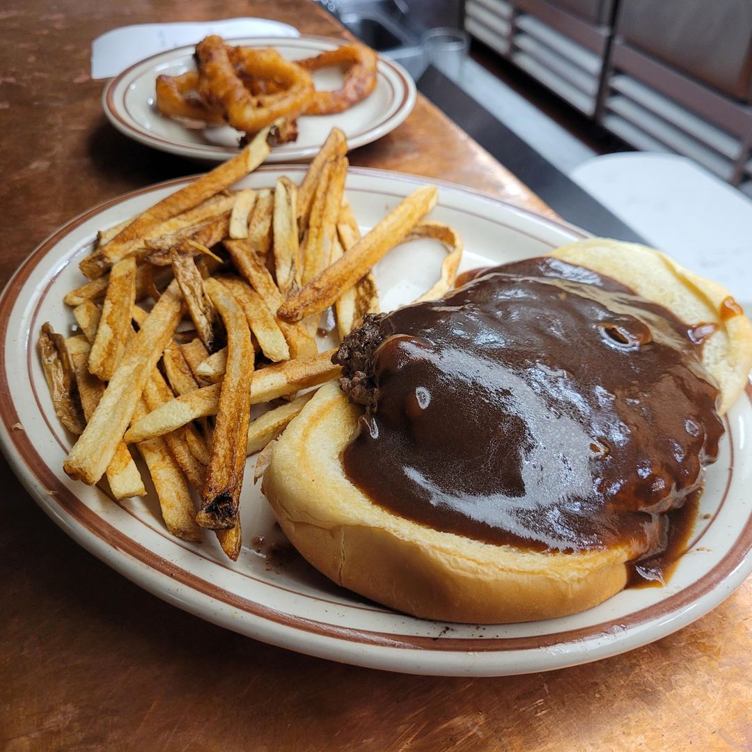 Open-faced burger smothered in brown gravy and served with Steer fries at The Black Steer in downtown Loveland, Colorado